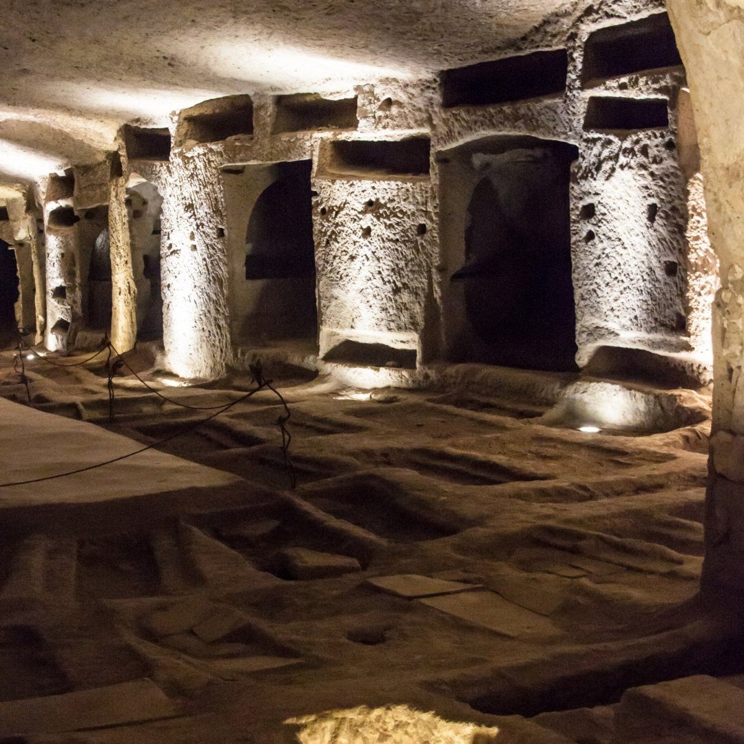 Carved tufa galleries and tombs inside the underground catacombs beneath Naples