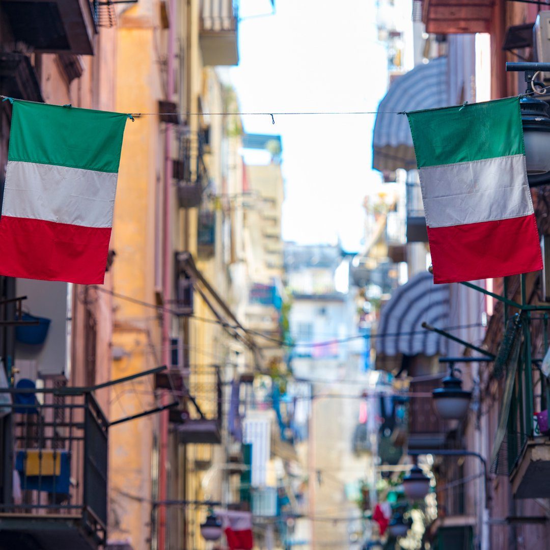Italian flags hanging across a narrow street in the Quartieri Spagnoli of Naples